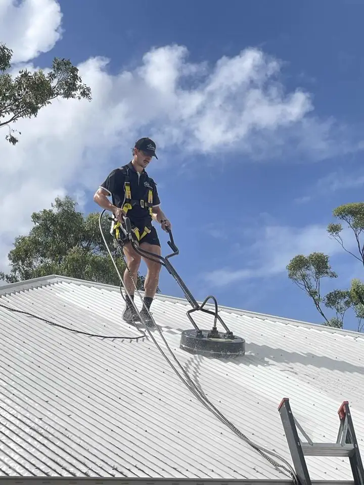 T and A Pro Cleaning roof technician using a safety harness